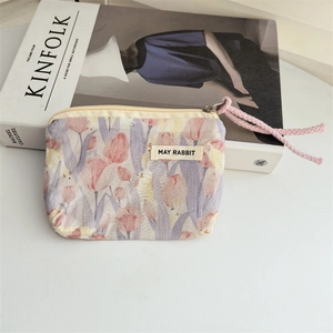 Close-up of cotton floral coin purse with May Rabbit tag on Kinfolk magazine
