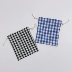 Detail view of small gingham drawstring bags in black and blue check patterns