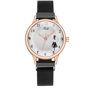 Close-up of rose gold watch case with mesh strap and textured dial featuring girl silhouette