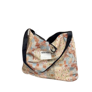 Ethnic patchwork denim tote bag with vintage floral patterns and SEEYOU label