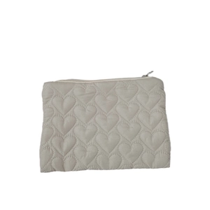 Quilted heart pattern makeup pouch in beige fabric with secure silver zipper closure