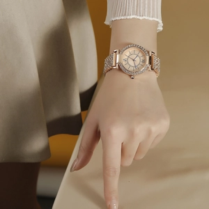 Luxury rose gold women's watch with rhinestone-encrusted steel band and starry dial