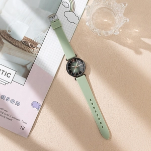 Detail of mint green quartz watch with dark green gradient sunray dial and rose gold markers