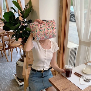 Detailed shot of a floral tulip canvas makeup bag with a stylish brand woven label