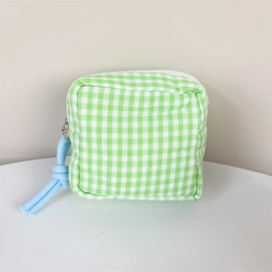 Detail of green and white gingham sanitary pouch with blue knotted rope zipper pull