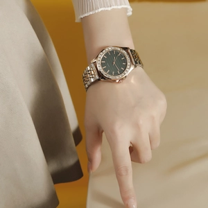 Women's quartz watch with diamond bezel, two-tone steel strap and textured dark dial