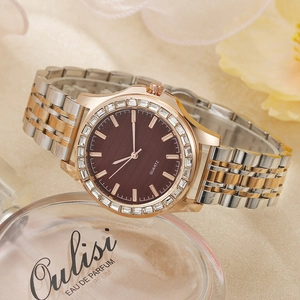 Detail of luxury ladies quartz watch featuring a crystal bezel and brown sunray dial