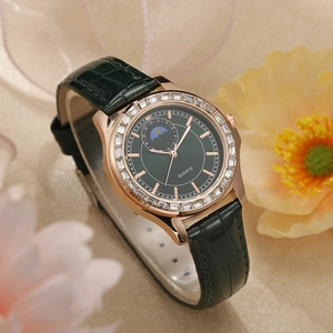 Gros plan détaillé d'une montre à quartz de luxe en or rose avec cadran vert et cristaux