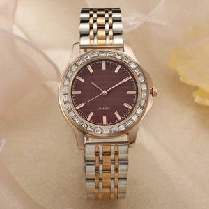 Detail of rose gold and silver watch with burgundy dial and crystal bezel decoration