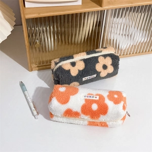 Plush floral pencil cases in dark grey and white fuzzy material with zipper closure