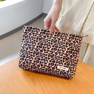 Detail showing the leopard print corduroy makeup bag with white May Rabbit woven label
