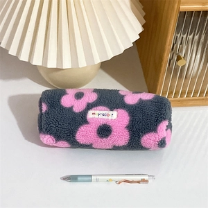 Close-up of plush floral pencil case with gray lamb wool and pink flower patterns