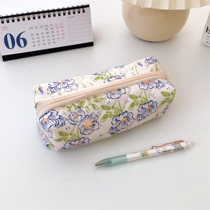 Close-up of quilted floral pencil case fabric texture with soft cotton padding and zipper