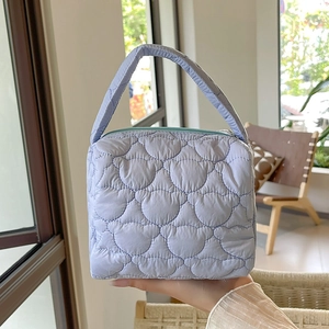 Detailed view of lavender quilted tote bag with unique teddy bear embroidery pattern