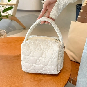 Quilted heart pattern white makeup bag with sturdy handle and secure zipper closure
