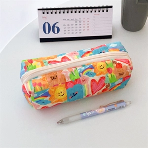 Close-up of quilted floral pencil case featuring colorful cartoon sun and bear patterns