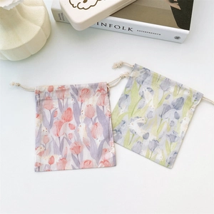 Detailed view of canvas drawstring pouches with elegant tulip and rabbit prints