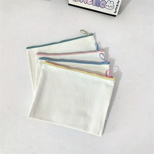 Set of four minimalist canvas zipper pouches in cream white with colored metal rings