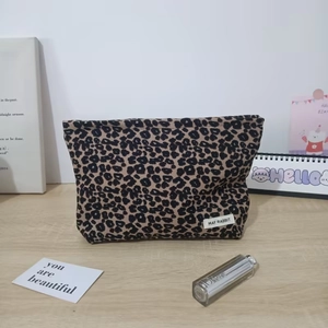 Detailed view of leopard print corduroy makeup bag with branded May Rabbit woven label