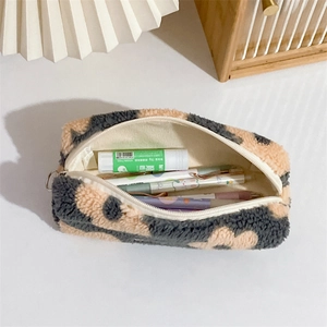 Detailed view of plush floral pouch showing soft texture and spacious stationery storage
