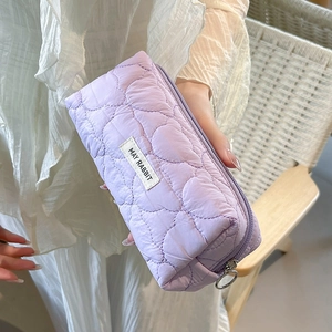 Close-up of lavender heart-quilted pencil case with MAY RABBIT label and silver ring zipper