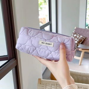 Detail of lavender quilted pencil case with heart pattern and May Rabbit woven label