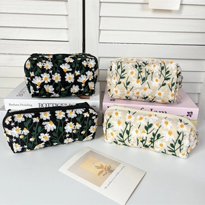 Daisy embroidered cosmetic bags in black and beige, set of four travel organizers