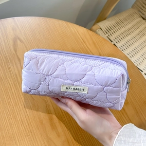 Detail of lavender quilted pencil case featuring cute bear patterns and a fabric logo