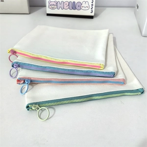 Detail of canvas pouches showing colorful plastic zippers and large circular pullers