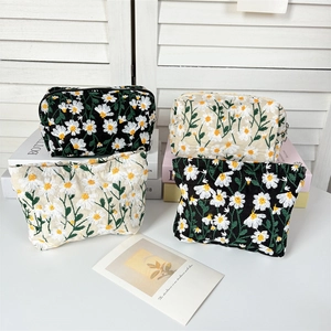 Floral daisy embroidered makeup bags in black and cream white for travel storage