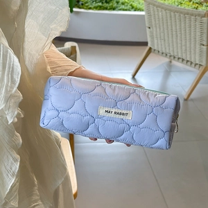 Detail of heart-quilted texture and zipper on this large capacity blue pencil case