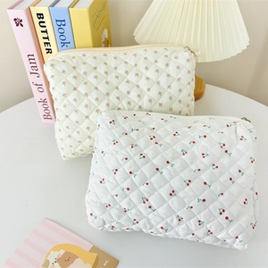 Floral and cherry print quilted makeup bags with secure gold zippers for daily storage