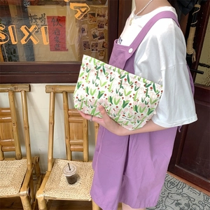 Close-up of floral canvas toiletry bag with tulip patterns and woven brand tag