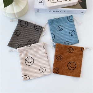 Corduroy smiley face drawstring storage pouch set in four bright minimalist colors