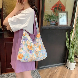 Retro floral canvas tote bag with large capacity for women shown in a casual lifestyle scene