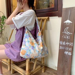 Close-up of floral print cotton tote bag with spacious interior and wide shoulder strap
