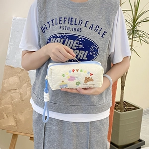 Quilted cream makeup bag with cute puppy embroidery and colorful rainbow lettering
