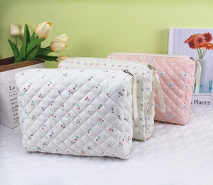 Detailed view of quilted cotton cosmetic bags with cherry, bear, and floral prints