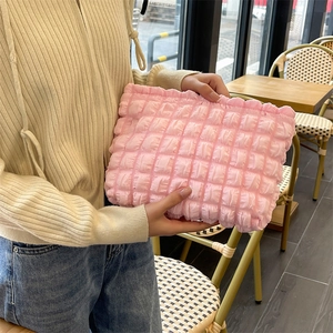 Detail shot of the pink bubble textured fabric on a soft puffer aesthetic makeup bag