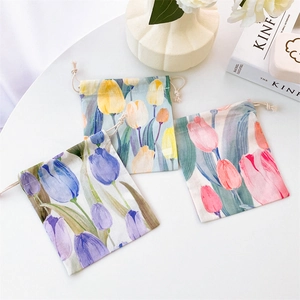 Detail view of floral tulip drawstring pouches in blue, orange, and pink colors