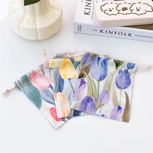 Three floral drawstring pouches with pink and orange tulip patterns on a white background