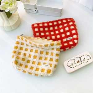 Large waffle texture cosmetic bags in vibrant orange and yellow with soft plush material