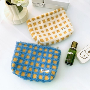 Checkered waffle plush makeup bags in yellow and blue colors for cosmetics storage
