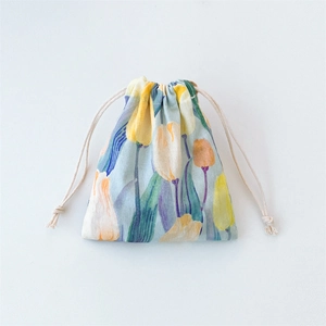 Close-up of floral drawstring storage bag with yellow tulips on light blue cotton fabric