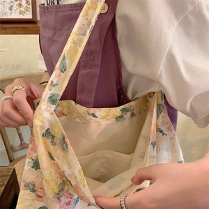 Detail shot of vintage floral canvas tote interior featuring a practical inner pocket