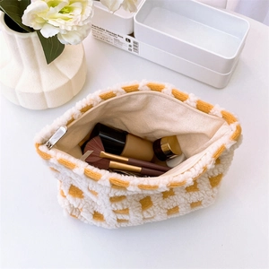 Macro view of checkered waffle makeup bag interior showing large storage capacity