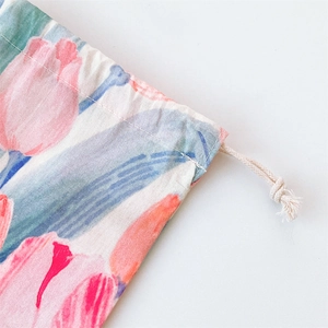 Close-up of tulip print drawstring bag showing sewing details and white woven cord