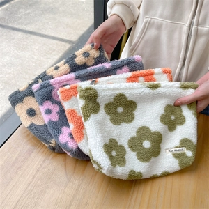 Detailed plush floral cosmetic bags with thick faux fur texture and secure zipper
