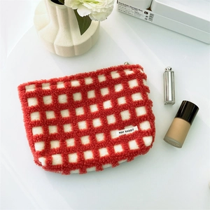 Macro shot of red waffle pattern makeup bag with soft fleece and smooth zipper detail