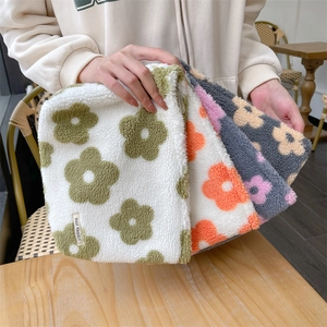 Macro shot of plush makeup bags with floral patterns and smooth zipper closures